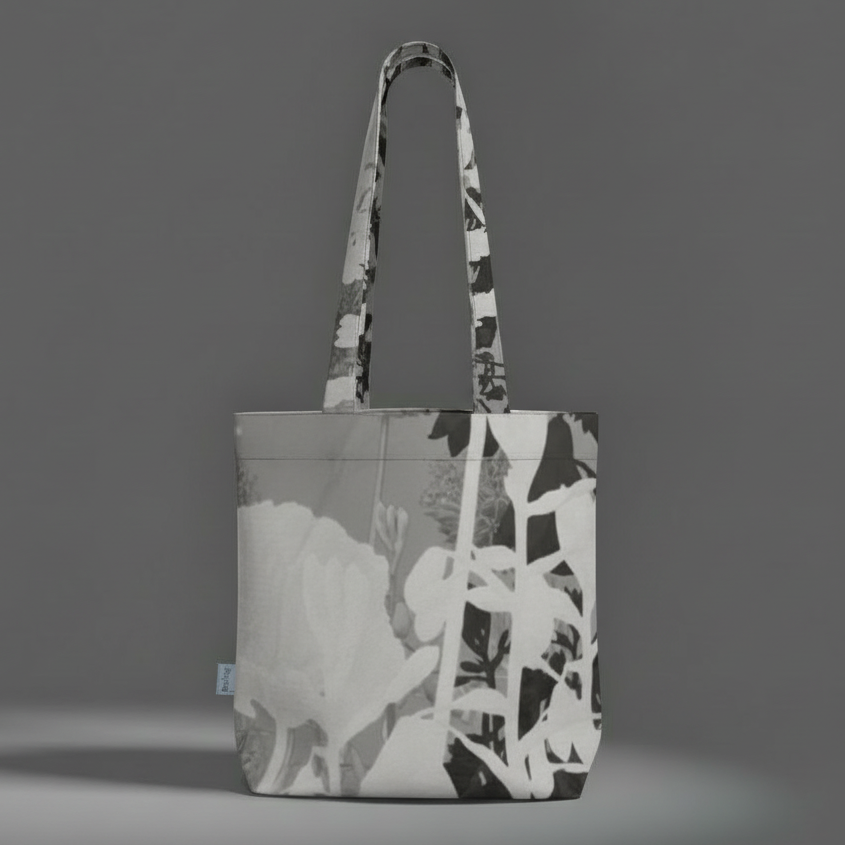Tote bag with a black and white abstract design on a gray background