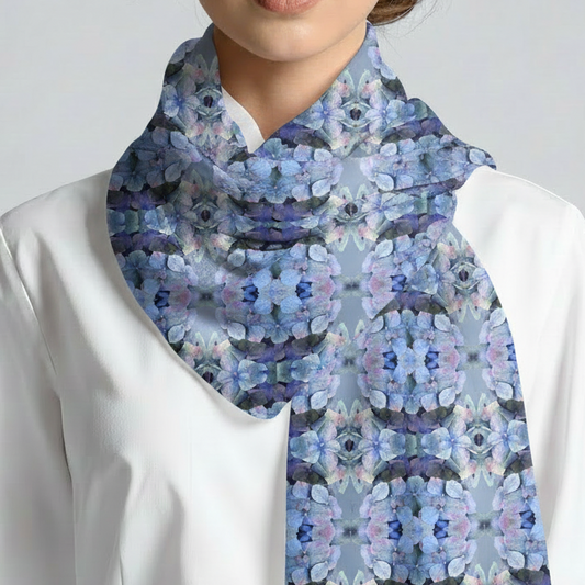 Person wearing a white shirt with a blue patterned scarf
