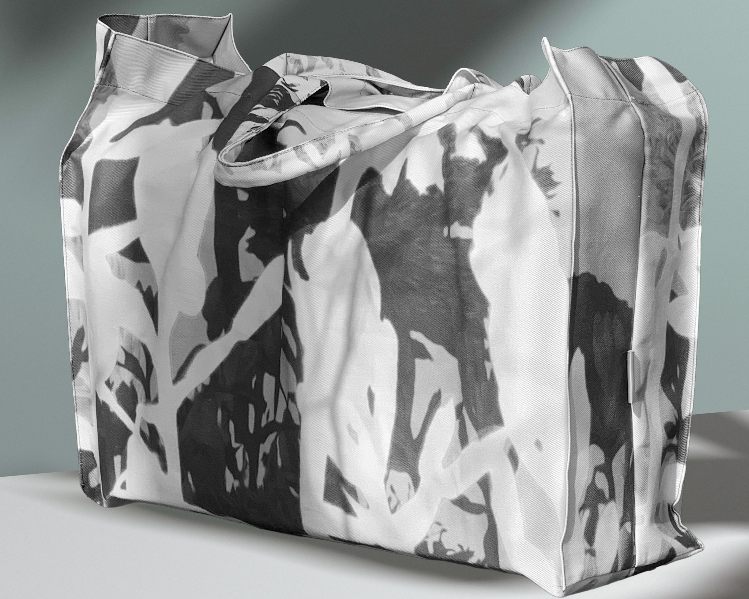 Tote bag with black and white abstract pattern on a gray background